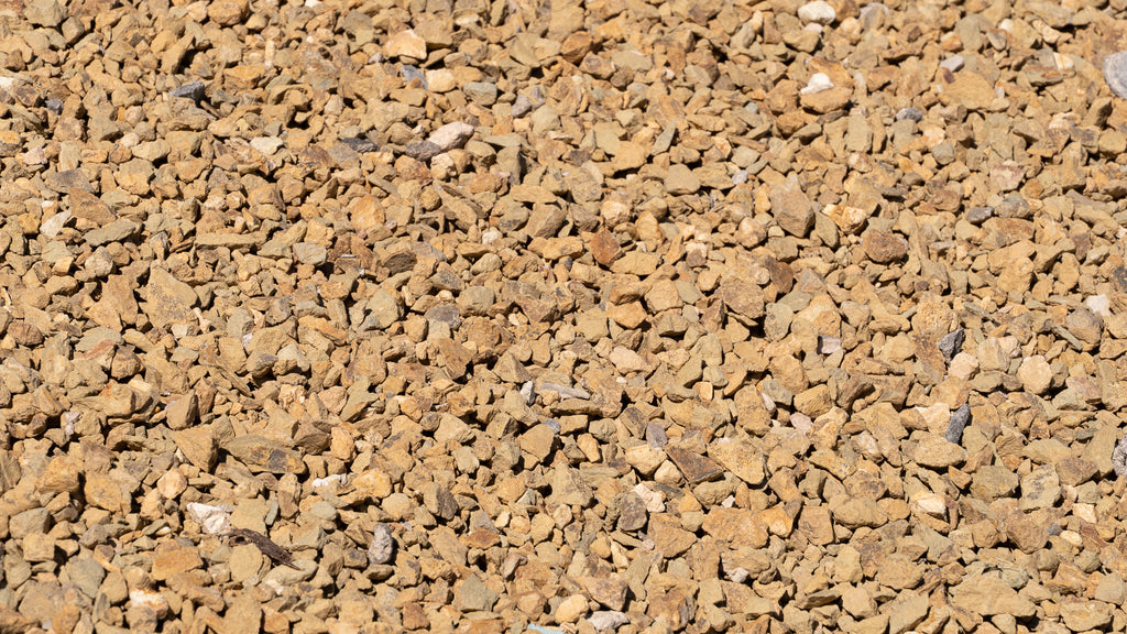 Gold 1/2 inch decorative rock, close-up