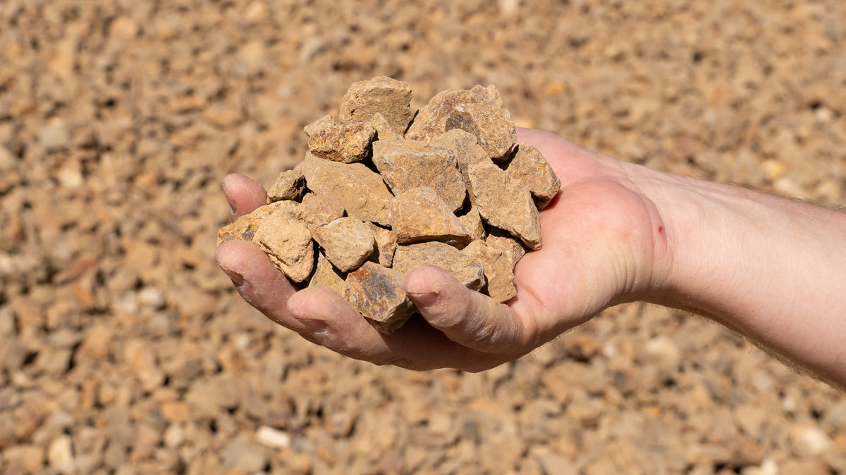 Mocha 3/4 inch decorative rock, handful showing size